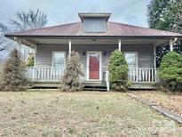 Quaint house with a wrap-around porch and mature landscaping at 2981 Old Nc 150 Hwy, Crouse, NC 28033