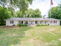 Ranch-style home with a metal roof and front porch at 8909 Highway 218 Hwy, Marshville, NC 28103