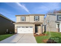 Two-story home with a two-car garage and landscaped yard at 311 Bezelle Ave, York, SC 29745
