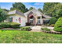 Two-story house with a manicured lawn and brick accents at 1375 Valhalla Dr, Denver, NC 28037