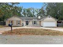 Brick ranch house with attached garage and a landscaped yard at 2218 Walters Division Rd, Monroe, NC 28110