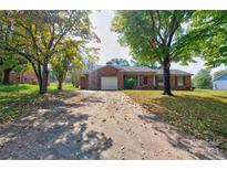 Brick ranch home with a carport and mature landscaping at 3119 Suffolk Dr, Shelby, NC 28152