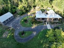 Aerial view of a ranch style home with a large driveway at 501 Journey Sw St, Concord, NC 28025