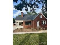 Brick ranch house with a sunroom and landscaping at 3980 Fish Pond Rd, Salisbury, NC 28146
