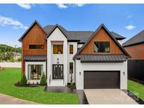 Modern two story home with stylish facade, attached garage, and manicured lawn at 5428 Carmel Rd, Charlotte, NC 28226