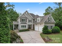 Two-story house with gray siding, attached garage, and landscaped yard at 235 Grey Rd, Davidson, NC 28036