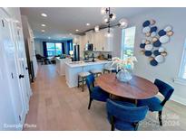 Modern open kitchen with island, breakfast bar and dining area at 2200 N Graham St # 12, Charlotte, NC 28206