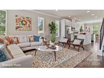 Open living room with contemporary furniture and kitchen views at 3004 Loso Ter # 56, Charlotte, NC 28217