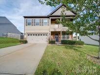 Two-story home with a two-car garage and landscaped yard at 131 Renville Pl, Mooresville, NC 28115