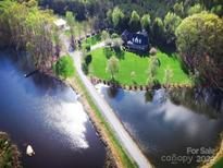 Aerial view of house on waterfront property with lush green landscape at 1011 Ratchford Rd, York, SC 29745