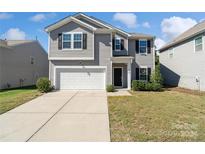 Two-story house with gray siding and a white garage door at 4928 Abendego Rd, Charlotte, NC 28213