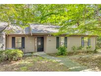 Tan colored house with mature landscaping and walkway at 151 Cedar Hollow St, Fort Mill, SC 29715