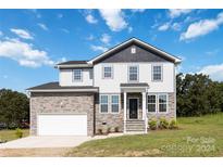 Beautiful two-story home with stone accents and a two-car garage at 1026 Heath Helms Rd, Monroe, NC 28110