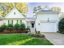 White two-story house with a two-car garage and green shutters at 272 Millingport Ln, New London, NC 28127