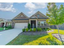 Brick ranch home with attached garage, landscaping, and paved driveway at 2014 Newstyle Way, Tega Cay, SC 29708