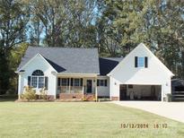 White house with a gray roof, a two-car garage, and a well-maintained lawn at 2318 Joseph Ct, Rock Hill, SC 29732