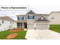 Two story home with two car garage and landscaping at 5090 Silver Creek Ln, Denver, NC 28037