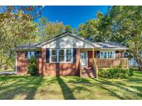 Brick ranch house with a covered porch and well-maintained lawn at 2554 W Chester School Rd, Chester, SC 29706