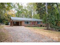 Brick ranch house with attached garage and landscaping at 1207 S Poplar St, Landis, NC 28088