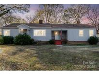 Ranch style home with gray siding, red steps and a spacious yard at 501 Hazel Ave, Kannapolis, NC 28083