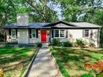 Charming brick ranch home with red door and landscaped yard at 508 Deese St, Monroe, NC 28112