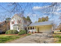 Charming two-story house with a carport and well-manicured lawn at 906 Wentworth Dr, Kannapolis, NC 28081