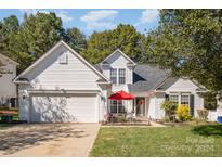 Two-story house with attached garage and landscaped yard at 6859 Lakecrest Ct, Denver, NC 28037