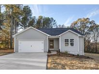 Newly constructed gray house with white garage door at 7066 Sparrow Ln, Vale, NC 28168