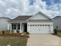 Charming one-story home with attached garage and manicured lawn at 1040 Bull Dog Ln, Wingate, NC 28174