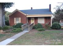 Brick house with a charming front porch and landscaped yard at 123 Stonewall St, Albemarle, NC 28001