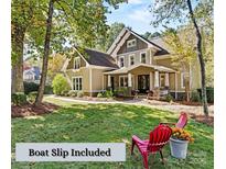 Two-story house with beige siding, stone accents, and a covered porch at 8903 Hillstone Ct, Sherrills Ford, NC 28673