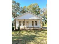 Newly renovated home with a front porch and lush lawn at 112 Maple St, Shelby, NC 28150