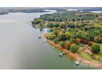 Aerial view of lakefront property with a pier and large yard at 459 Kenway Loop, Mooresville, NC 28117