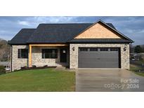 Charming two-story home with a mix of brick and wood siding, attached garage, and front yard at 4916 Southview Dr, Hickory, NC 28602