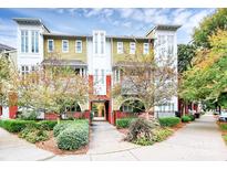 Modern building exterior with yellow siding, landscaping and walkway at 2200 Lyndhurst Ave # 202, Charlotte, NC 28203