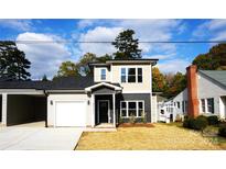 Two-story craftsman style home with gray siding, a white garage door, and landscaping at 1022 W C St, Kannapolis, NC 28081