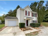 Two-story house with attached garage and well-manicured landscaping at 3219 Irwin Valley Ct, Charlotte, NC 28269