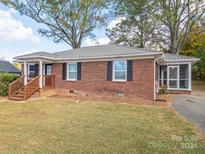 Brick ranch house with a wooden staircase and landscaping at 210 N Hoyle St, Cherryville, NC 28021