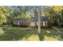 Brick ranch home with a landscaped yard and walkway at 201 Smithfield Dr, Charlotte, NC 28270