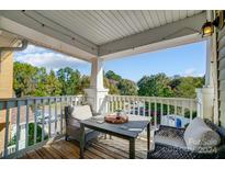 Private balcony with table and chairs, offering a relaxing outdoor space at 16440 Redstone Mountain Ln, Charlotte, NC 28277