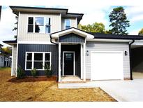 Two-story home with gray and beige siding, black door, and attached garage at 1024 W C St, Kannapolis, NC 28081
