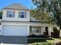 Two-story house with a white exterior, gray shutters, and a two-car garage at 5536 Stowe Derby Dr, Charlotte, NC 28278