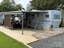 Spacious RV site with covered parking, golf cart, and storage shed at 134 Dove Ln, New London, NC 28127