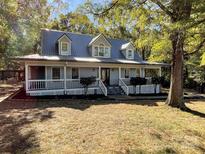 Two-story home with gray siding, white trim, and a porch at 3018 Castlebrook Dr, Monroe, NC 28112