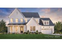 Two-story house with white brick, gray roof, and a two-car garage at 5304 Mint Harbor Way # 0287, Charlotte, NC 28269