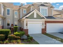 Townhouse exterior with brick and siding, two-car garage at 45014 Wigeon Ln # 100, Indian Land, SC 29707