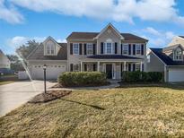 Two-story house with landscaped lawn and attached garage at 114 Laporte Ln, Mooresville, NC 28115