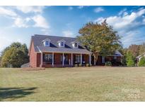 Brick house with front porch, landscaping, and large yard at 223 Adrian Rd, Salisbury, NC 28146