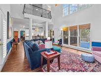 Open living room with high ceilings and large windows offering backyard views at 5303 Shasta Hill Ct, Charlotte, NC 28211