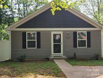 Gray house with gray vinyl siding, white trim and black shutters at 1025 Old Charlotte Rd, Statesville, NC 28677